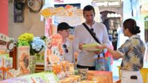 Foreign tourists visit Qilou Old Street in Haikou, S China's Hainan
