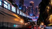 Cyberpunk Chongqing! Train emerges from beneath the road
